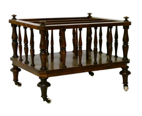 Early Victorian walnut Canterbury of three divisions, the rectangular frame on spindle-turned supports, four turned legs and 