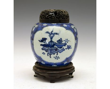 Chinese ovoid jar having blue and white painted decoration with two reserves showing antiques and artefacts on a prunus decor