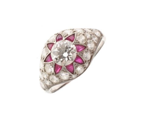 Diamond and calibré ruby bombé ring, unmarked, the central brilliant cut of approximately 0.8 carats, enclosed by eight trian