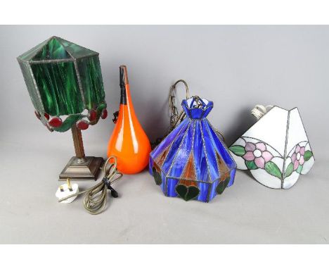 A collection of lighting to include table lamps, Tiffany style wall light, 1960's Swedish light shade.Condition Report: The o