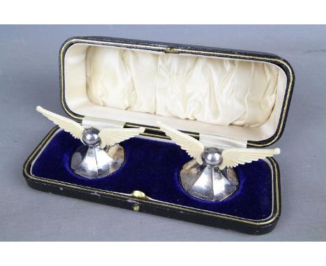 A pair of George V hallmarked silver and bone knife rests in the form of wings on splayed bases, Sheffield assay 1910, sponso