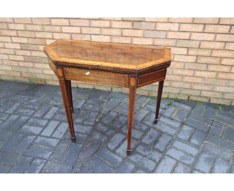 A George III mahogany and satinwood card table, the canted front rectangular top crossbanded and enclosing a baize lined play