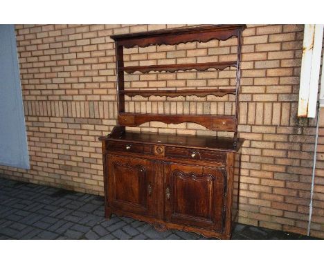 French Dresser - a late 18th century walnut dresser base with two drawers over a pair of pointed ogee shaped panelled cupboar