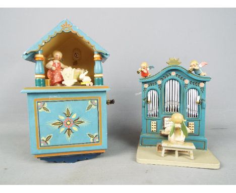Two Erzgebirge hand painted wooden music boxes. [2]Condition Report: Organ form box movement does not appear to function, key