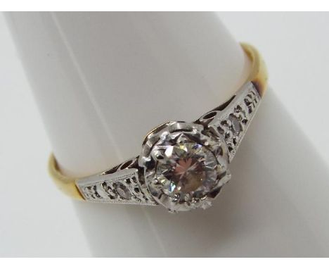 A lady's 18ct platinum ring, illusion set with a single stone diamond, approximately 0.25ct, each shoulder set with a small s