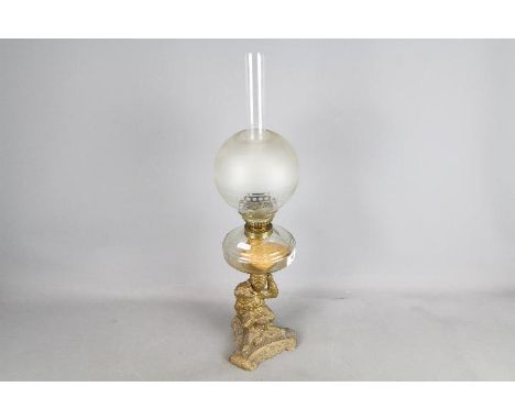 A good quality oil lamp, the support column in the form of a bear holding the oil font, approximately 59 cm (h). Est £50 - £8