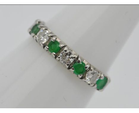 An 18ct white gold, emerald and diamond, half eternity ring, size K, approximately 1.5 grams all in. Est £50 - £80