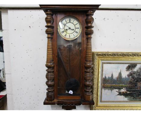 A late 19th / early 20th century Vienna style walnut cased wall clock, Roman numerals on an enamel and brass dial behind a gl