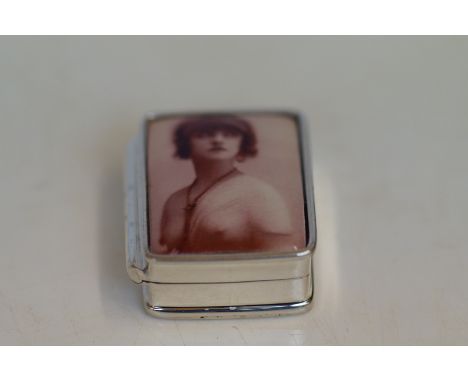 Silver pill box depicting a nude lady in the enamel