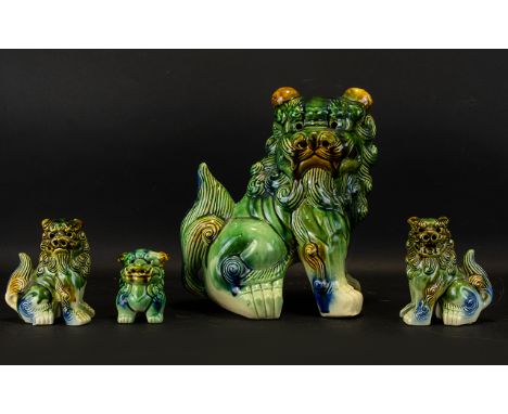 A Collection Of Four Oriental Dogs Of Foo/ Guardian Lions Modern ceramic figures in traditional stance with blue, green and b