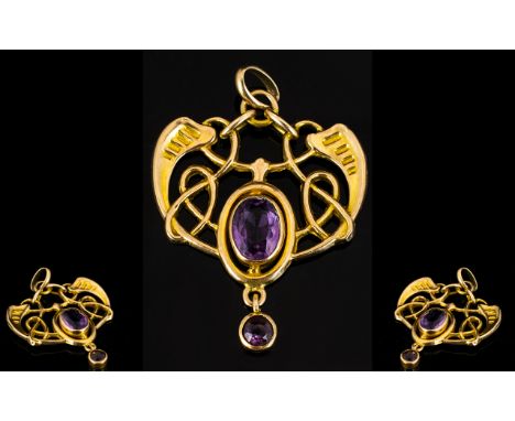 A 9ct Gold Art Nouveau Pendant Set with an oval faceted amethyst with amethyst drop of Celtic design, fully hallmarked, maker