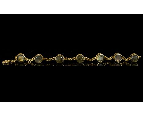 Labradorite Station Bracelet, seven round cut labradorites, totalling 19cts, displaying the blue/green and golden inner light