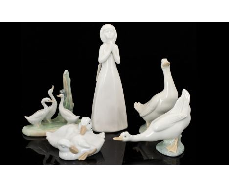 A Collection of Porcelain Figures, to include:  White Royal Doulton 'God Bless You' Praying figure 8.5" high; Nao ornament of