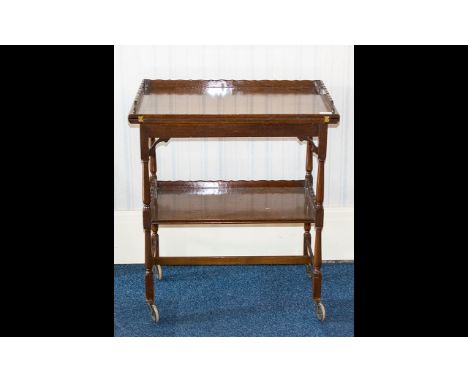 A 1920's Mahogany Trolley Of rectangular form with tilt and swivel top revealing a brown baize card table with turned support