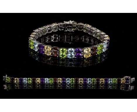 Red Garnet, Peridot, Amethyst, Sky Blue Topaz and Citrine Two Row Bracelet, 29cts of the gemstones, each oval cut, set in pai