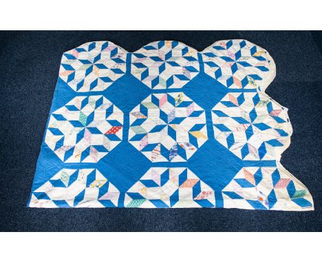 An Early 20th Century American Patchwork Quilt Hand stitched in polychrome printed patches and light blue diamond patches - t