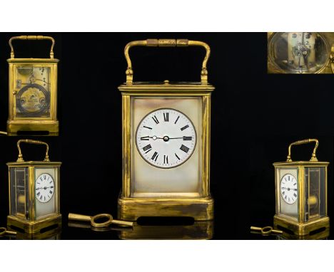 French Repeating Carriage Clock Of typical form with brass lacquered case, white porcelain dial and Roman numerals, backplate