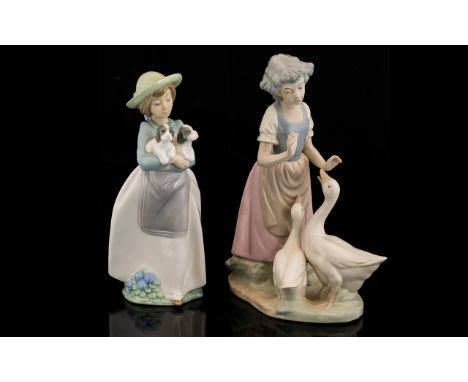 Two Nao by Lladro Figures comprising "What An Armful" 1156 Figurine - Girl Holding Two Puppies/ Dogs 10.5 inches high and fig