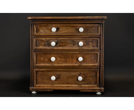 A Small Four Drawer Graduating Beechwood Chest The drawers  finished with white ceramic handles, height 16 inches, 16 x 12 in