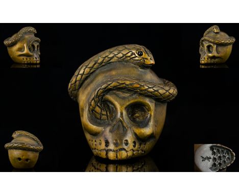 Japanese 19th Century Signed Boxwood Netsuke in the form of a Human Skull with entwined snake around the skull.  Signed to un
