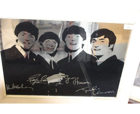 A MIRRORED PRINT depicting The Beatles rock band, 58cm x 44cm 