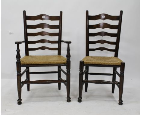 A SET OF SIX OAK LANCASHIRE LADDER BACK STYLE CHAIRS with raffia strung seats on turned pad foot legs