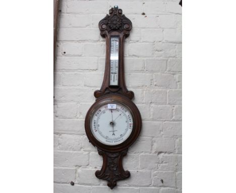 AN OAK CASED ANDROID DIAL BAROMETER with card case, thermometer, the dial signed 'Chancellor & Son, Dublin', 92cm high