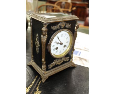 A 19TH CENTURY FRENCH EBONISED MANTLE CLOCK with gilt metal mounts, the enamelled dial with Roman numerals, overall 22cm high