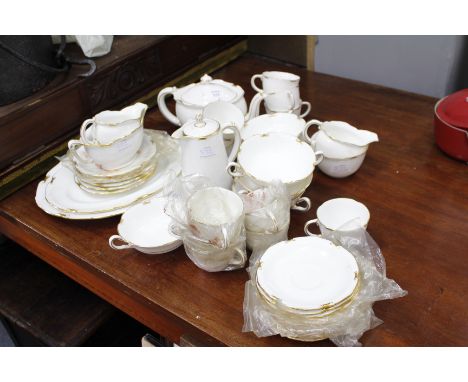 A ROYAL CROWN DERBY REGENCY PATTERN PART TEA SET with cups, saucers, a tea pot, two milk jugs, and a sugar bowl together with