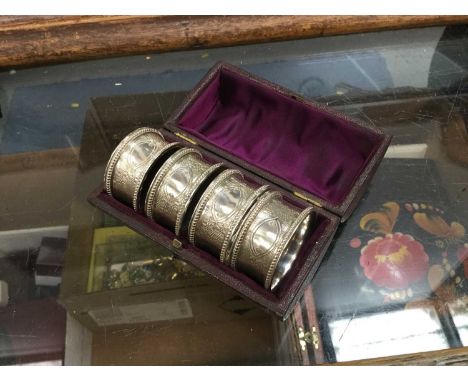 Set of four Victorian silver napkin rings with engraved engine turned decoration and vacant cartouche in original fitted leat