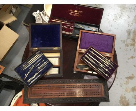 Three 19th century mathematical instrument sets and inlaid cribbage board