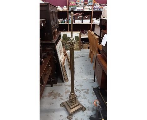 Late Victorian brass corinthian column standard lamp converted to electricity on paw feet