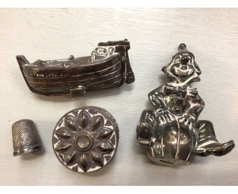 Group silver items to include seated clown ornament, small boat, trinket pot and a thimble