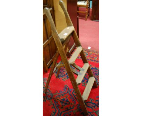 An early 20th century pitched pine low decorator's ladder, of hinged form 