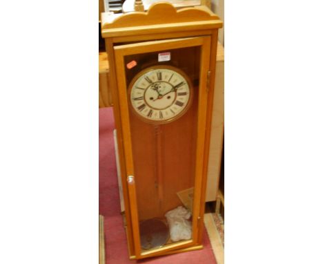 A contemporary beech drop trunk wall clock having twin weights and pendulum
