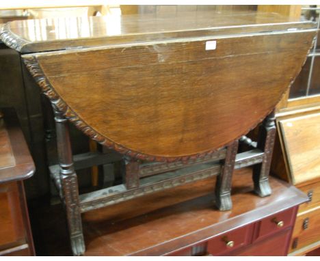 A 19th century low relief carved oak drop leaf dining table, having a gate leg action and on braganza feet, length 101cm
