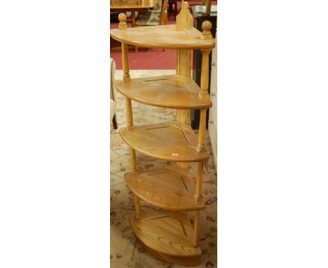 A contemporary Ercol blond elm five tier open corner shelf