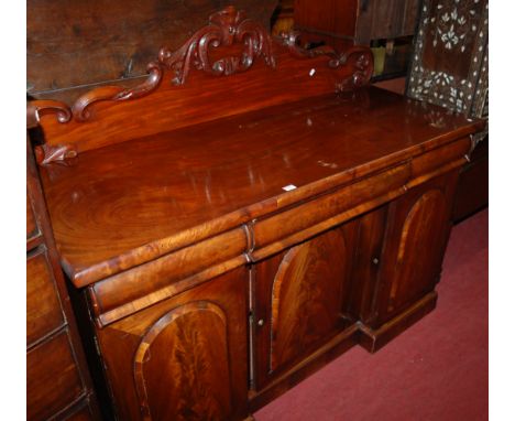 A mid Victorian mahogany and flame mahogany ledgeback sideboard, having three cushion frieze drawers over three further cupbo