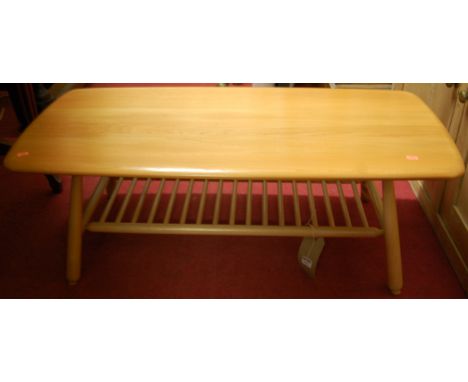 A contemporary Ercol blond elm low round cornered coffee table, having ladder rack undertier, length 104cm