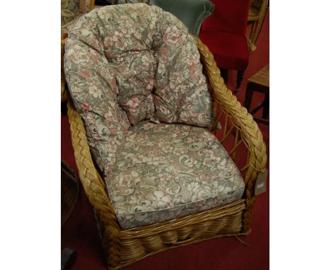 A pair of wicker tub shape conservatory armchairs having floral cushion upholstery