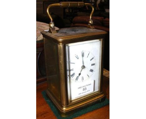A 13cm high brass cased carriage clock CONDITION REPORTticks for a few seconds then stops, needs a clean.