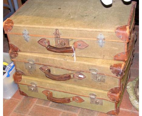 Three vintage leather and canvas suitcases 