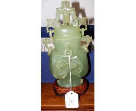A carved jade pot and cover with wooden stand in fitted case - the jade 20cm high CONDITION REPORTseems fine