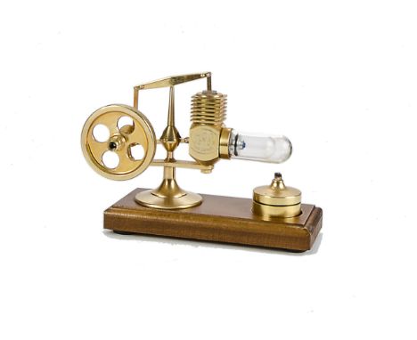 A H0G-Mikrostirling 24-carat gold-plated Hot Air engine: standing approx 4” high, with 2” diameter flywheel and glass heating