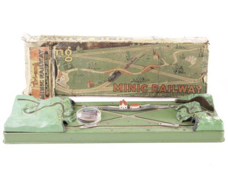 A Triang Minic Railway (approx 000 scale) battery-powered set: including metal-based layout with plastic locomotive and two c