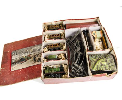 A Bing 0 Gauge clockwork GWR Train Set: in original box, containing fixed-key locomotive 3410 (gears stripped), tender, two c