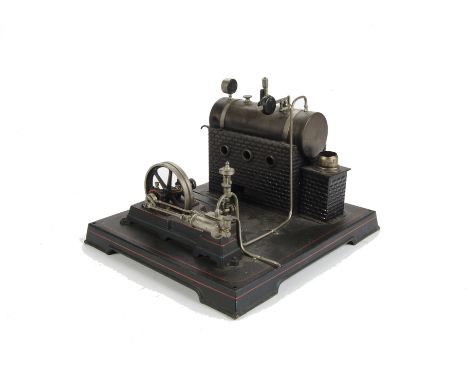 A Live Steam Stationary Engine by Doll: single fixed cylinder horizontal engine mounted on baseplate approx 11” x 12”, with 3
