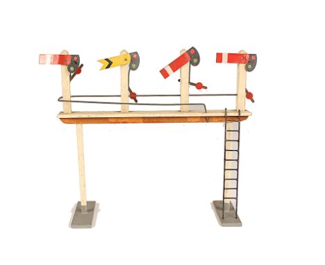 An uncommon early post-war Wooster 0 Gauge wooden Signal Gantry, with three Home and one Distant Signals, each with a lever, 