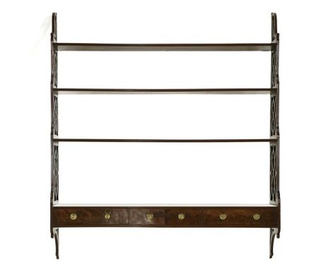 A George III mahogany four-tier open wall shelf, with latticed sides, over two drawers, labelled 'Apter Fredericks Ltd.', 107