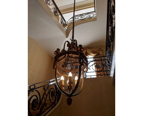 A large Louis XVI-style ormolu and glass hall lantern, 20th century, with scrolling supports over four faux sconces, four-pan